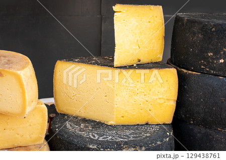 Assorted cheese varieties at a market stall 129438761