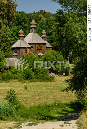 Old wooden church on a background of blue sky 129439649