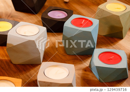 colorful candles in wooden candlesticks 129439716