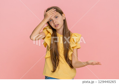 Child girl kid doing facepalm to show shame or disappointment in funny awkward imaginary situation Child girl kid doing facepalm to show shame or disappointment in funny awkward imaginary situation 129440265