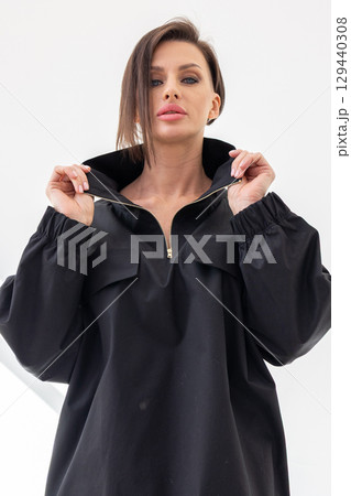 Portrait of beautiful woman in black jacket close-up on white background. Studio photography. Vertical photo. High quality photo Portrait of beautiful woman in black jacket close-up on white background. Studio photography. Vertical photo. High quality photo 129440308