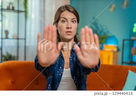 Woman says No hold palm folded crossed hands, warning of finish, prohibited access stop gesture 129440418
