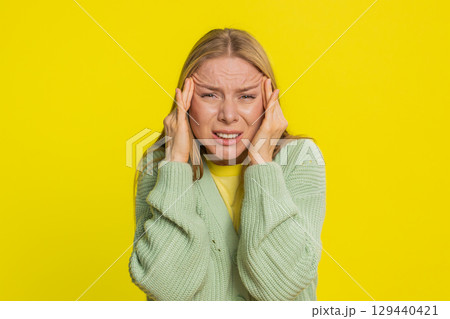 Woman rubbing temples to cure headache problem, suffering from tension and migraine stress pain Woman rubbing temples to cure headache problem, suffering from tension and migraine stress pain 129440421