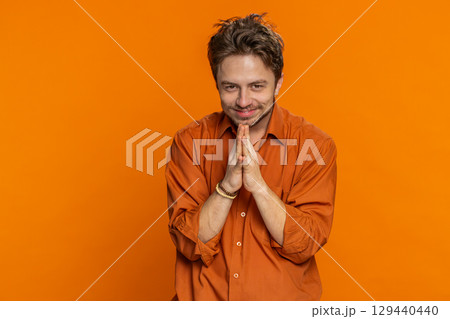 Sneaky cunning Caucasian young man thinking over devious villain idea cheats jokes pranks evil plan Sneaky cunning Caucasian young man thinking over devious villain idea cheats jokes pranks evil plan 129440440