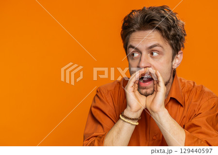 Caucasian man whisper news rumors holding hands near mouth share gossip quiet keep my secrets 129440597