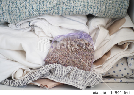 Organizing a closet with fresh linens and lavender sachets Organizing a closet with fresh linens and lavender sachets 129441661