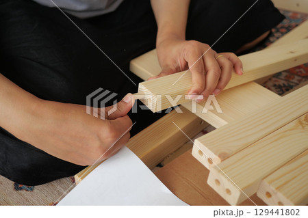 Constructing wooden furniture with precision and care Constructing wooden furniture with precision and care 129441802