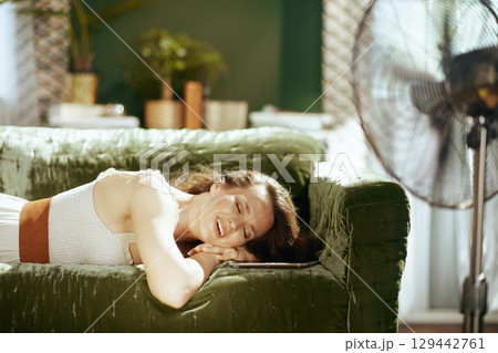 Serene Woman Resting on Sofa with Digital Tablet 129442761