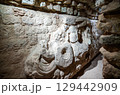Intricate stone sculpture on a wall inside an archaeological excavation tunnel at the Mayan ruins of Copan, a UNESCO World Heritage site in Honduras 129442909