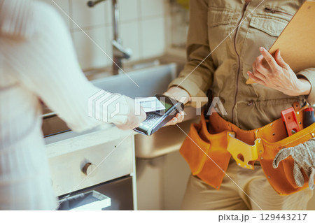 Paying for Home Plumbing Service 129443217