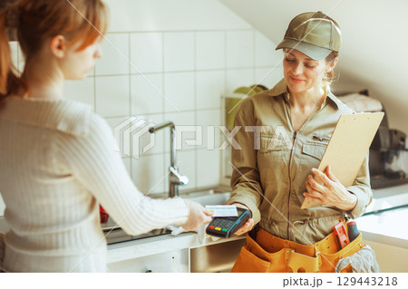 Home Repair Payment: Card Transaction in Kitchen 129443218