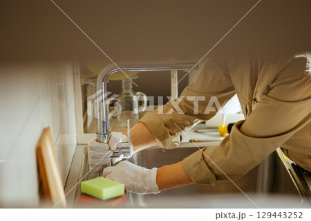 Fixing Faucet: Kitchen Sink Maintenance 129443252