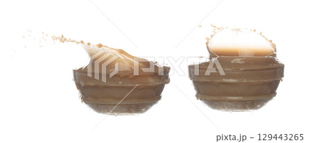 Milk Tea fall pouring down in Shape form line. Milk Ice coffee splash spill drop droplet out of glass, chocolate cocoa attack fluttering explosion in air. White background isolated, stop motion Milk Tea fall pouring down in Shape form line. Milk Ice coffee splash spill drop droplet out of glass, chocolate cocoa attack fluttering explosion in air. White background isolated, stop motion 129443265