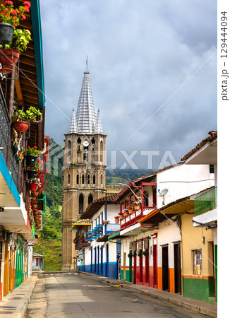 The Neo-Gothic Basilica of the Immaculate Conception rises above a colorful colonial street in the picturesque mountain town of Jardin, Colombia The Neo-Gothic Basilica of the Immaculate Conception rises above a colorful colonial street in the picturesque mountain town of Jardin, Colombia 129444094