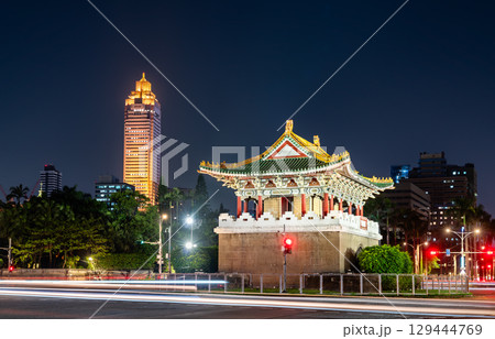 The historic Jingfu Gate (East Gate) in a traffic circle at night, with Taipei modern city skyline and traffic light trails in the background, Taiwan The historic Jingfu Gate (East Gate) in a traffic circle at night, with Taipei modern city skyline and traffic light trails in the background, Taiwan 129444769