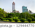 Historic National Taiwan Museum and a modern skyscraper rise above 228 Peace Memorial Park with manicured bushes in Taipei, Taiwan 129444770