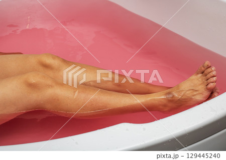 Indulging in a Relaxing Bath with Beautiful Pink Water and Soft, Calming Tones for Pure Bliss Indulging in a Relaxing Bath with Beautiful Pink Water and Soft, Calming Tones for Pure Bliss 129445240