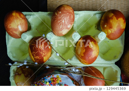 Close-up view of chicken eggs, homemade easter cake and willow twigs 129445369