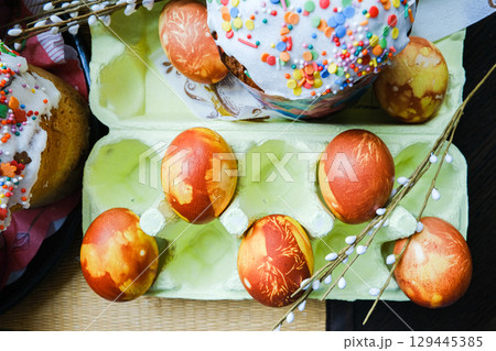 Close-up view of chicken eggs, homemade easter cake and willow twigs 129445385