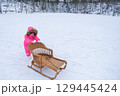 A child carries a tube up the hill 129445424