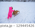 A child carries a tube up the hill 129445426