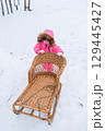 A child carries a tube up the hill 129445427