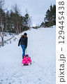 A child carries a tube up the hill 129445438