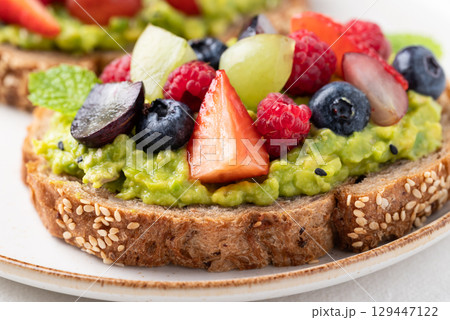Avocado toast with strawberry, blueberry, raspberry and grape. Healthy eating Avocado toast with strawberry, blueberry, raspberry and grape. Healthy eating 129447122