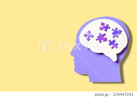 Colorful design featuring a silhouette with puzzle pieces 129447291
