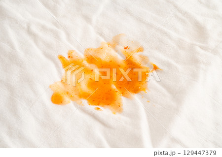 Dirty tomato sauce stain or ketchup on cloth to wash with washing powder, cleaning housework. 129447379