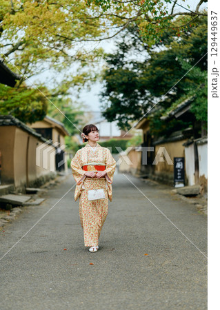 武家屋敷群を散策する着物姿の女性 129449637