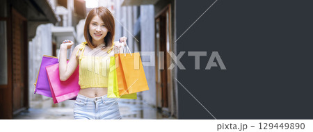 Banner Shopping bags of women crazy shopaholic person at fashion mall. Web Banner Woman love online shopping website holding shopping bags in hands with copy space. digital marketing happy lifestyle 129449890