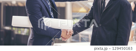 Teamwork partner two men team shaking hands together. Businessman contractor handshake with Business Partner Trust Partnership. Industrail people contractor dealing mission team meeting office desk 129450163