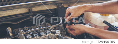 Banner Mechanic man hands repairing car shop. Man hands fixing Car machinery vehicle mechanical service. Panorama open vehicle hood checking up auto mobile. Car maintenance engineer with copy sapce 129450165