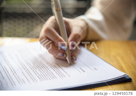 Businesswoman hands note meeting document in conference room. Woman Hands writing planning on notebook. Female hand holding pencil write on diary sketchbook. Business Planning Concept. Businesswoman hands note meeting document in conference room. Woman Hands writing planning on notebook. Female hand holding pencil write on diary sketchbook. Business Planning Concept. 129450178