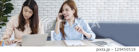 Banner Happy success business woman partner meeting working together in company office. Panoramic picture of Meeting Executive Asian business woman office desk with fist arm raised executive teamwork Banner Happy success business woman partner meeting working together in company office. Panoramic picture of Meeting Executive Asian business woman office desk with fist arm raised executive teamwork 129450519