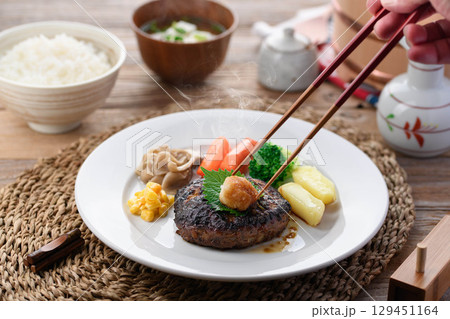 湯気立つ和風おろしハンバーグと彩り野菜の定食 温かい家庭料理やレストランメニューに最適 湯気立つ和風おろしハンバーグと彩り野菜の定食 温かい家庭料理やレストランメニューに最適 129451164