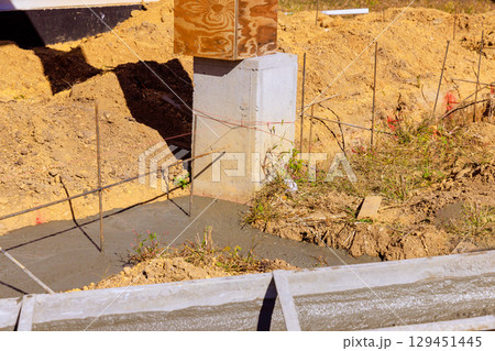 Concrete is being poured for foundation of new building at construction site 129451445