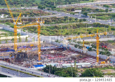 Aerial View Of A Busy Construction Site With Multiple Tower Cranes Working. 129451485