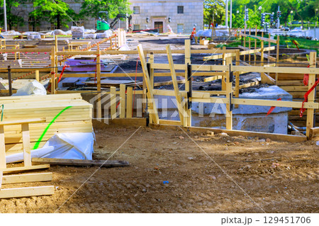 Wooden structures soil are prepared at busy urban construction site in construction area 129451706