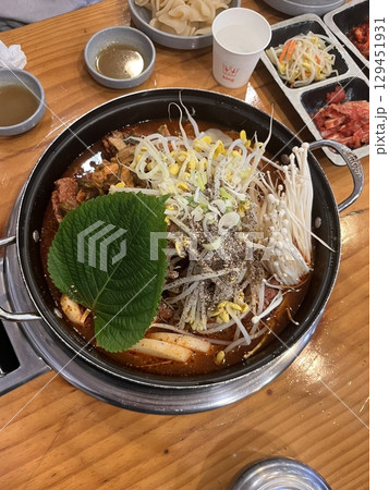 Rich and hearty gamjatang, a Korean pork bone soup with tender meat, potatoes, and vegetables in a spicy, flavorful broth. A comforting dish perfect for a satisfying meal. 129451931