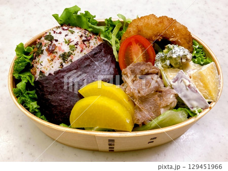 A traditional Korean dosirak, beautifully arranged with rice, assorted banchan, and savory proteins. Balanced and visually inviting, its a portable meal packed with vibrant flavors. A traditional Korean dosirak, beautifully arranged with rice, assorted banchan, and savory proteins. Balanced and visually inviting, its a portable meal packed with vibrant flavors. 129451966
