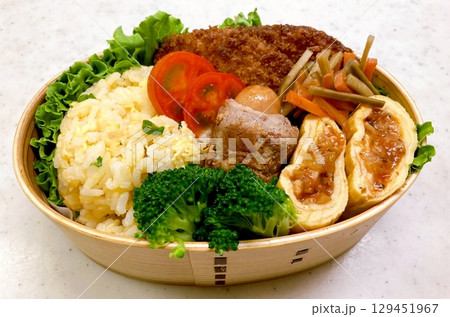 A traditional Korean dosirak, beautifully arranged with rice, assorted banchan, and savory proteins. Balanced and visually inviting, its a portable meal packed with vibrant flavors. A traditional Korean dosirak, beautifully arranged with rice, assorted banchan, and savory proteins. Balanced and visually inviting, its a portable meal packed with vibrant flavors. 129451967