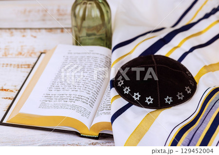 1 August 2025 Jerusalem Israel Kippah rests alongside Jewish prayer book tallit on rustic wooden surface in calming atmosphere synagogue "Hebrew Tanakh prayer holy book" 1 August 2025 Jerusalem Israel Kippah rests alongside Jewish prayer book tallit on rustic wooden surface in calming atmosphere synagogue "Hebrew Tanakh prayer holy book" 129452004