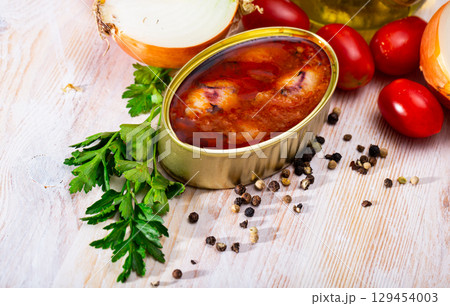 Canned stuffed squid in American sauce in open tin can, nobody Canned stuffed squid in American sauce in open tin can, nobody 129454003