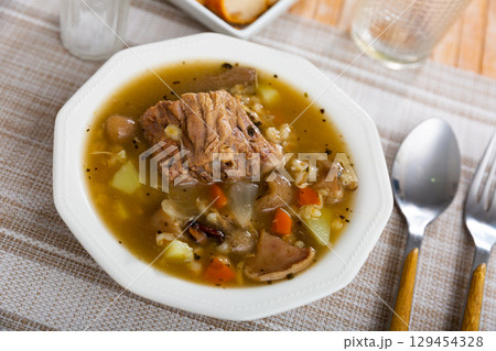 Pork and mushroom soup with vegetables and pearl barley Pork and mushroom soup with vegetables and pearl barley 129454328