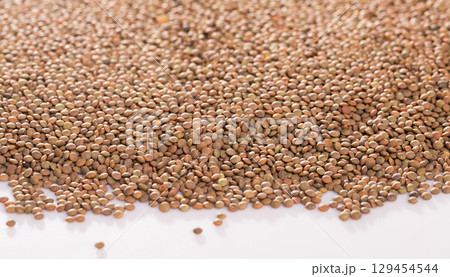 Raw lentils on white background Raw lentils on white background 129454544