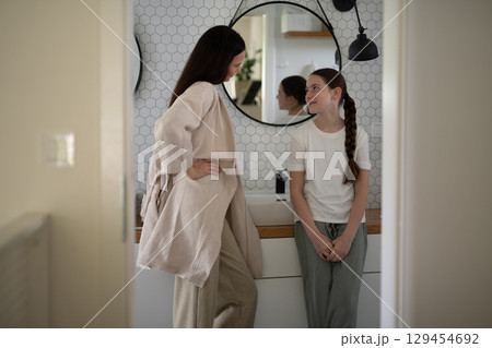 mother and daughter sharing a moment in the bathroom mother and daughter sharing a moment in the bathroom 129454692