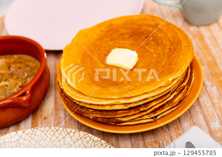 Thin pancakes with butter and machanka of meat with vegetables and mushrooms 129455785
