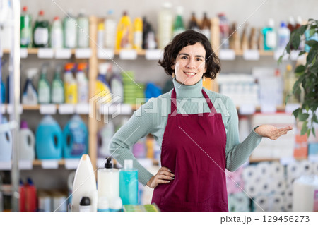 Middle-aged saleswoman welcoming clients in retail store Middle-aged saleswoman welcoming clients in retail store 129456273